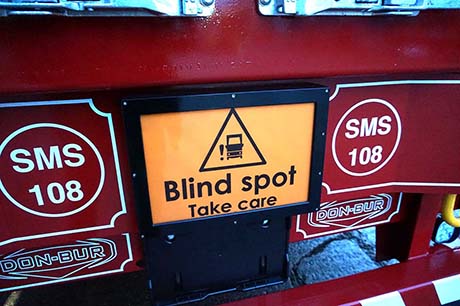flashing blind spot sign